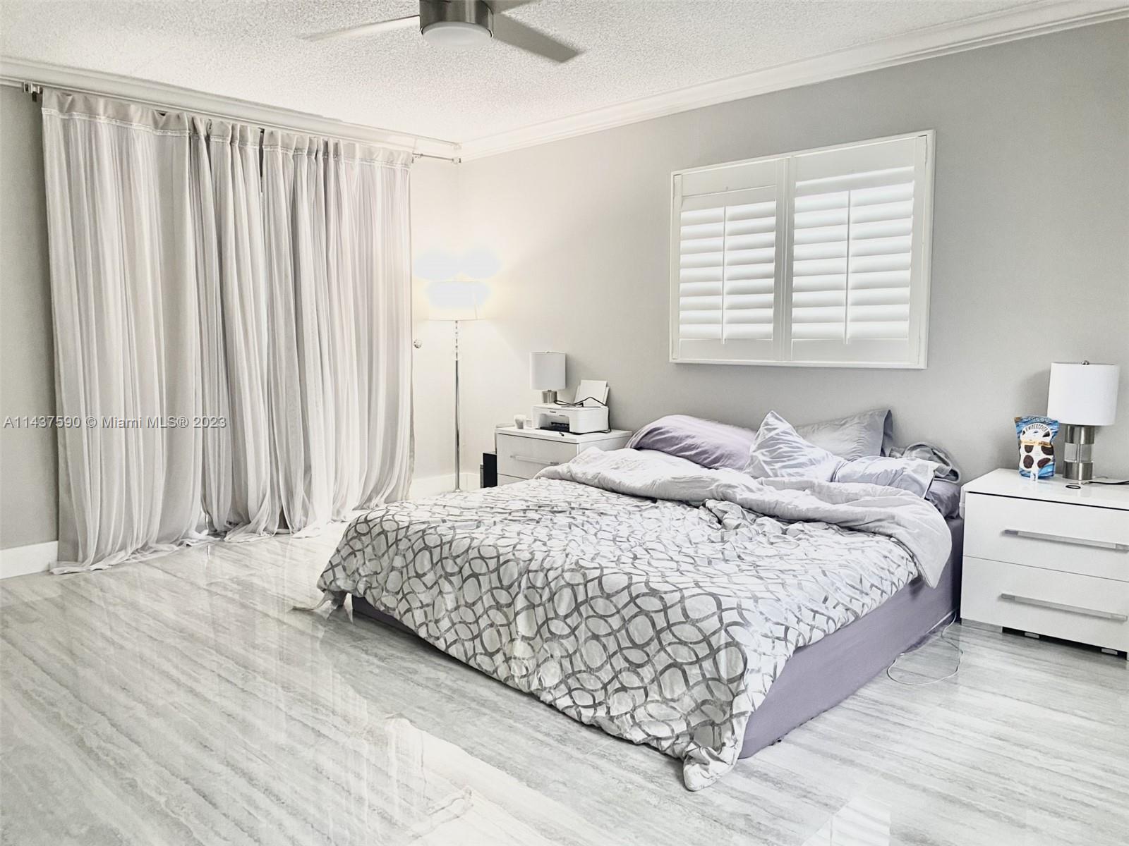 22620 Southwest 65th Way Boca Raton, FL 33428 - Photo 13 of 23 a bedroom with a bed and a window