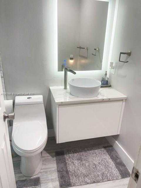22620 Southwest 65th Way Boca Raton, FL 33428 - Photo 15 of 23 a white toilet sitting next to a bathroom sink