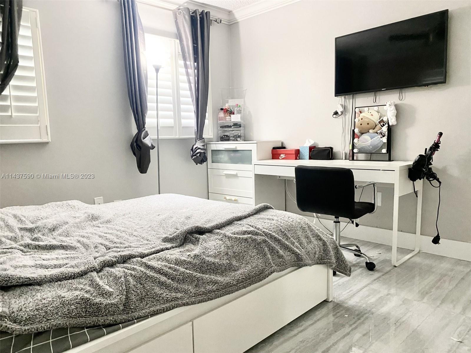 22620 Southwest 65th Way Boca Raton, FL 33428 - Photo 16 of 23 a bedroom with a bed and a flat screen tv