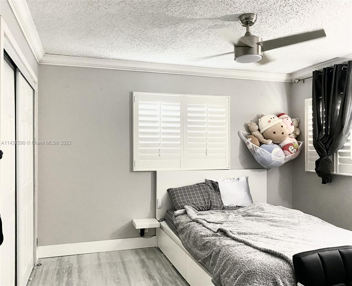 22620 Southwest 65th Way Boca Raton, FL 33428 - Photo 17 of 23 a bedroom with a bed and a chandelier