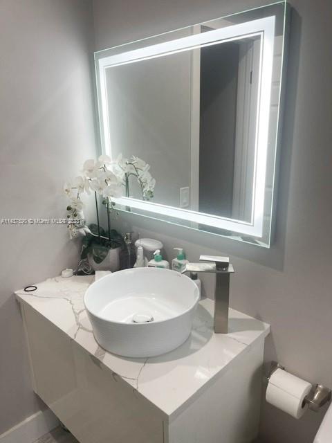 22620 Southwest 65th Way Boca Raton, FL 33428 - Photo 20 of 23 a bathroom with a sink and a mirror