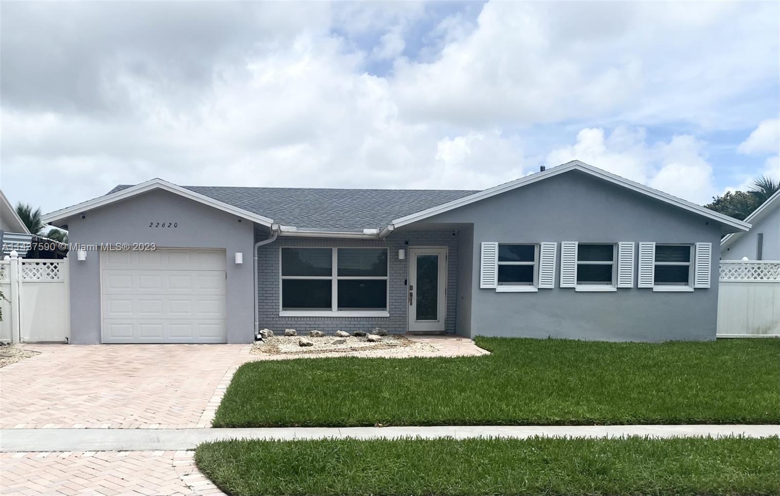 22620 Southwest 65th Way Boca Raton, FL 33428 - Photo 2 of 23 a front view of house with yard and green space
