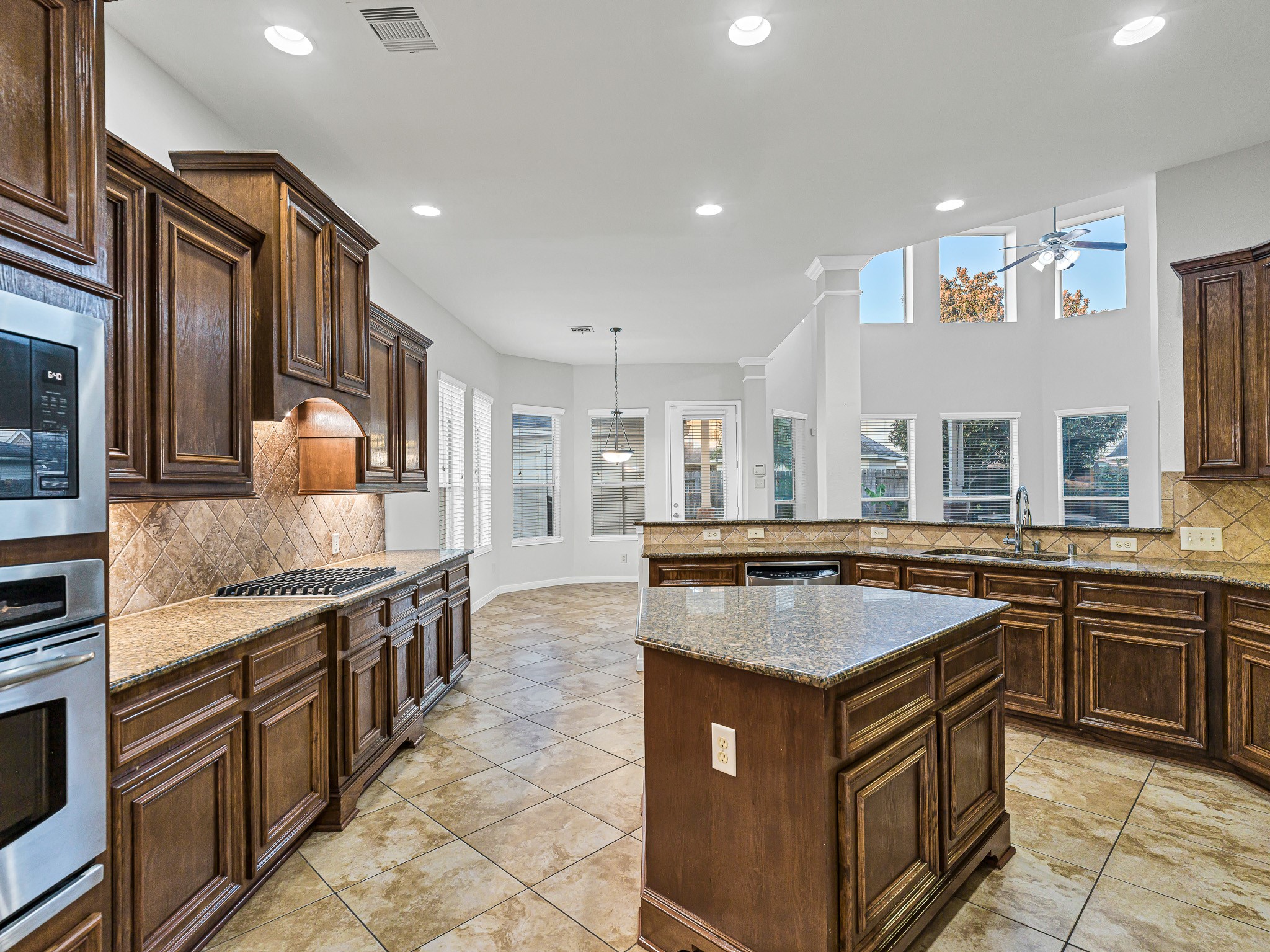 2714 Misty River Lane Richmond, TX 77406 - Photo 13 of 50 a kitchen with stainless steel appliances granite countertop a stove and a sink
