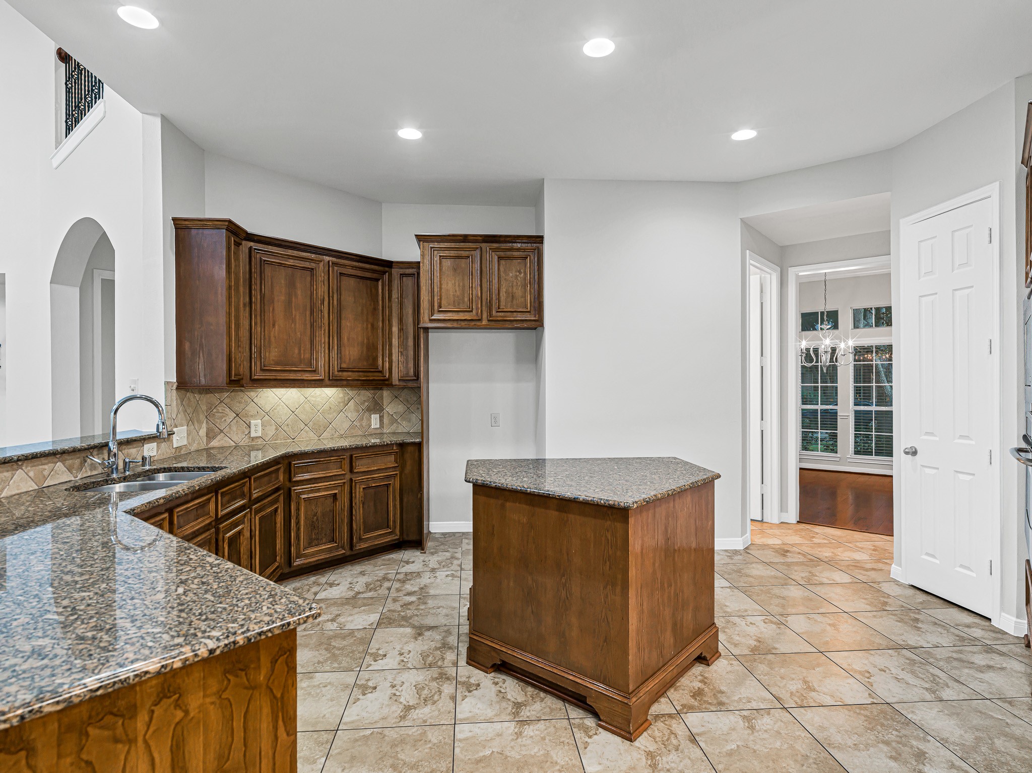 2714 Misty River Lane Richmond, TX 77406 - Photo 16 of 50 a kitchen with stainless steel appliances granite countertop a sink stove and cabinets