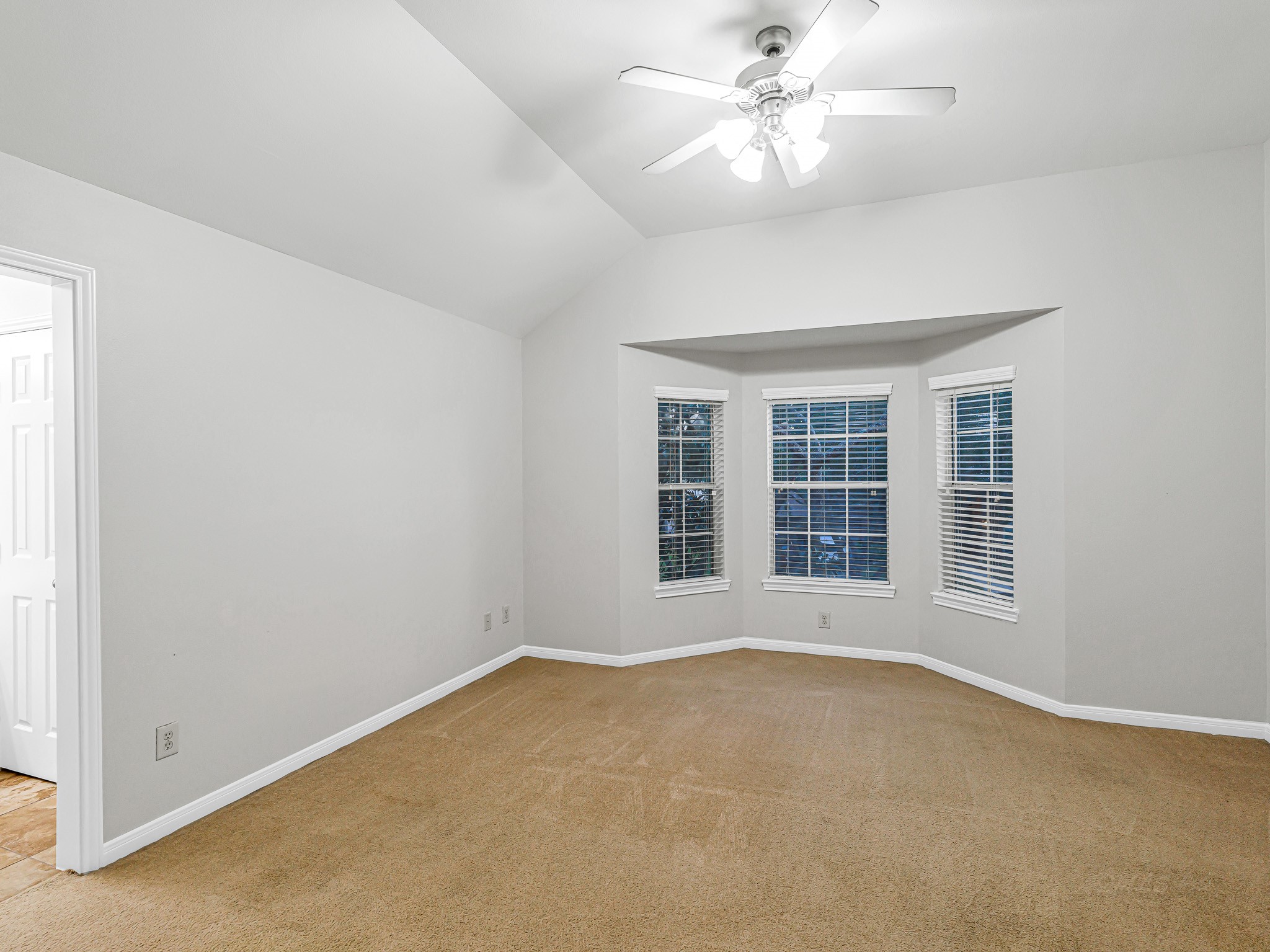 2714 Misty River Lane Richmond, TX 77406 - Photo 37 of 50 an empty room with a window and a ceiling fan