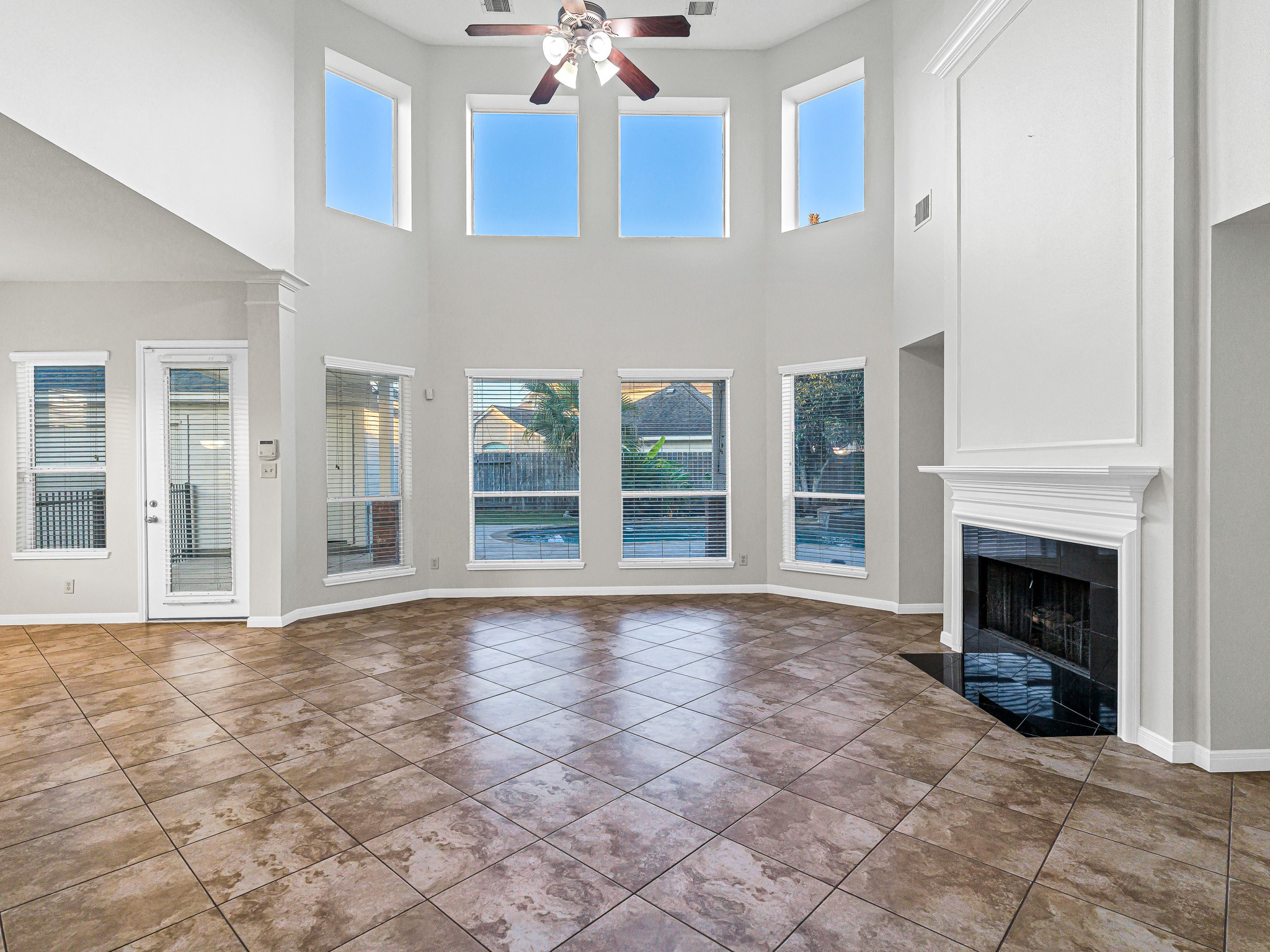 2714 Misty River Lane Richmond, TX 77406 - Photo 5 of 50 a view of an empty room with fireplace and windows