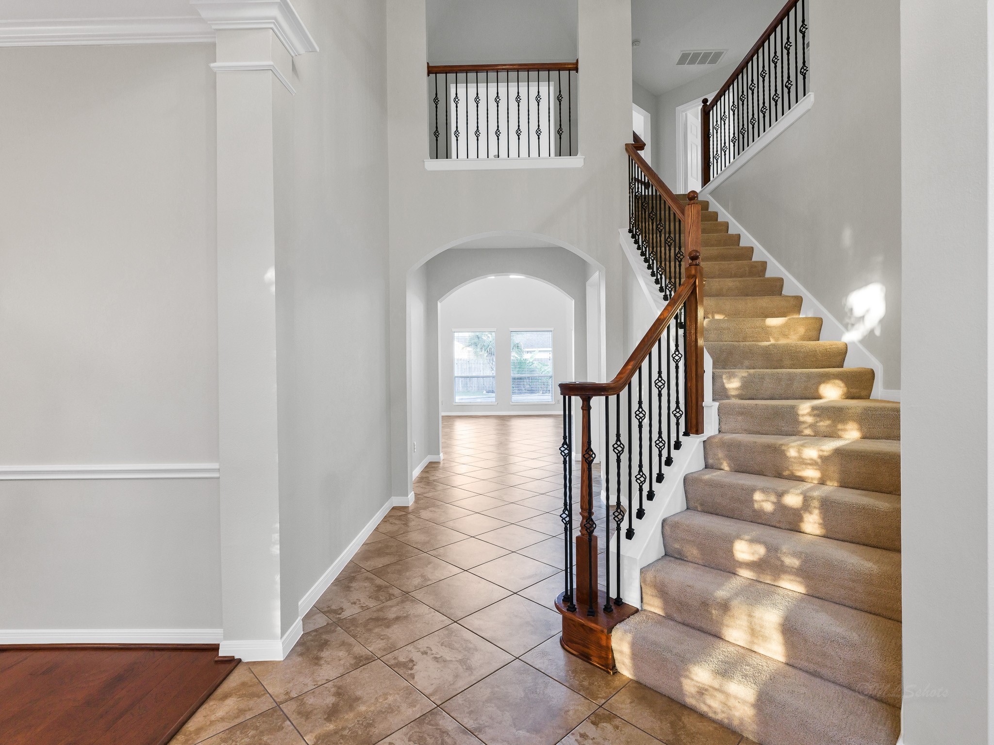 2714 Misty River Lane Richmond, TX 77406 - Photo 6 of 50 a view of staircase with lots of frames on wall and a window