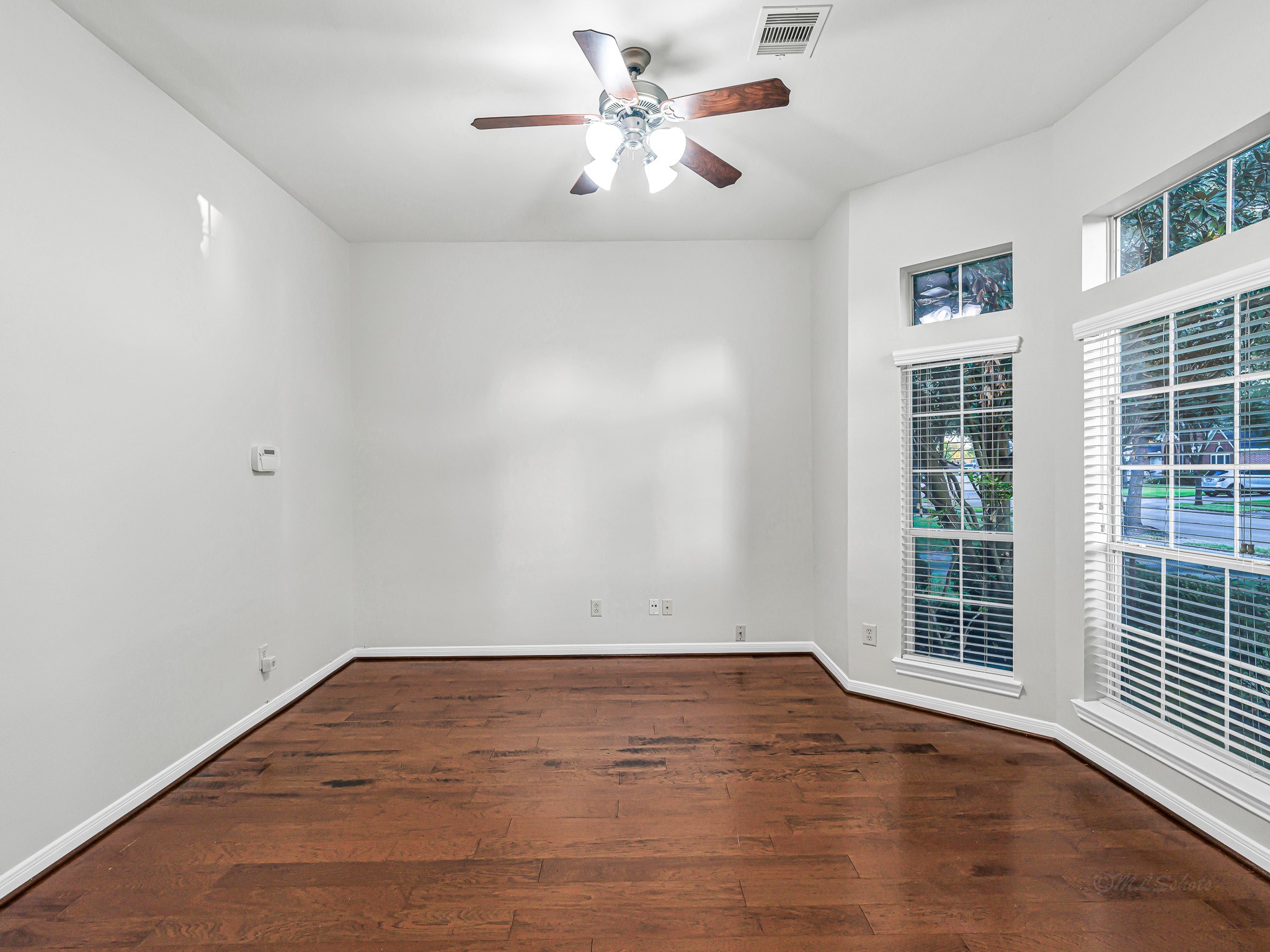 2714 Misty River Lane Richmond, TX 77406 - Photo 8 of 50 a view of a room with wooden floor and a ceiling fan