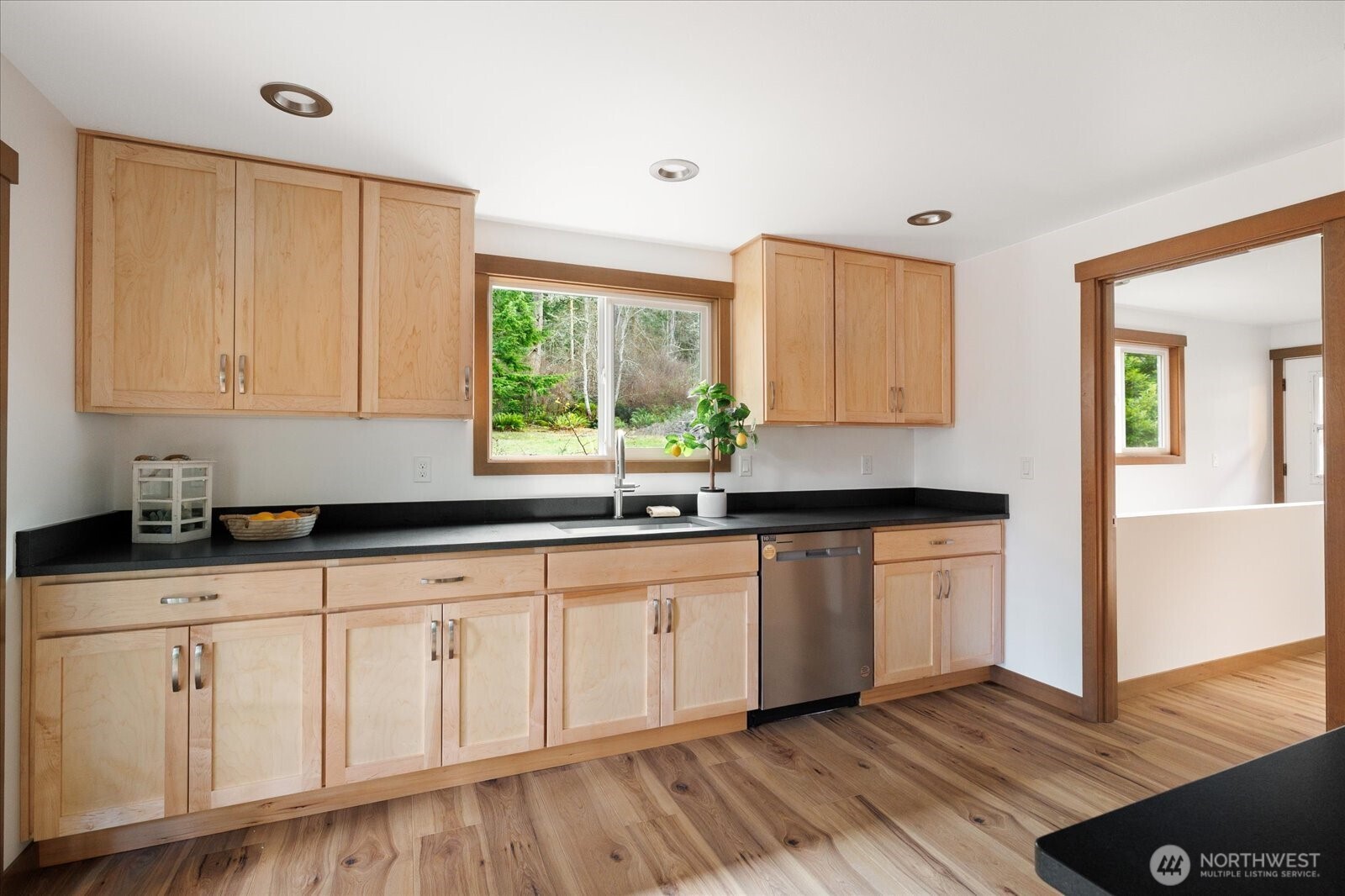 2341 Libbey Road Coupeville, WA 98239 - Photo 12 of 36 a kitchen with granite countertop white cabinets white appliances a sink and wooden floor