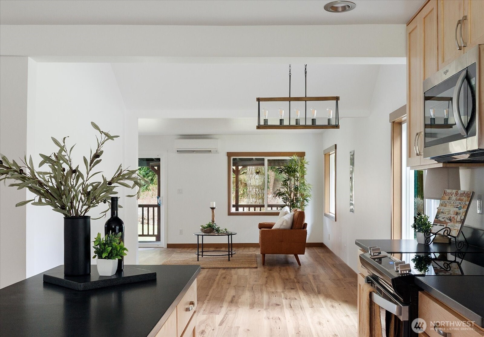 2341 Libbey Road Coupeville, WA 98239 - Photo 14 of 36 a living room with furniture a chandelier a rug and a window