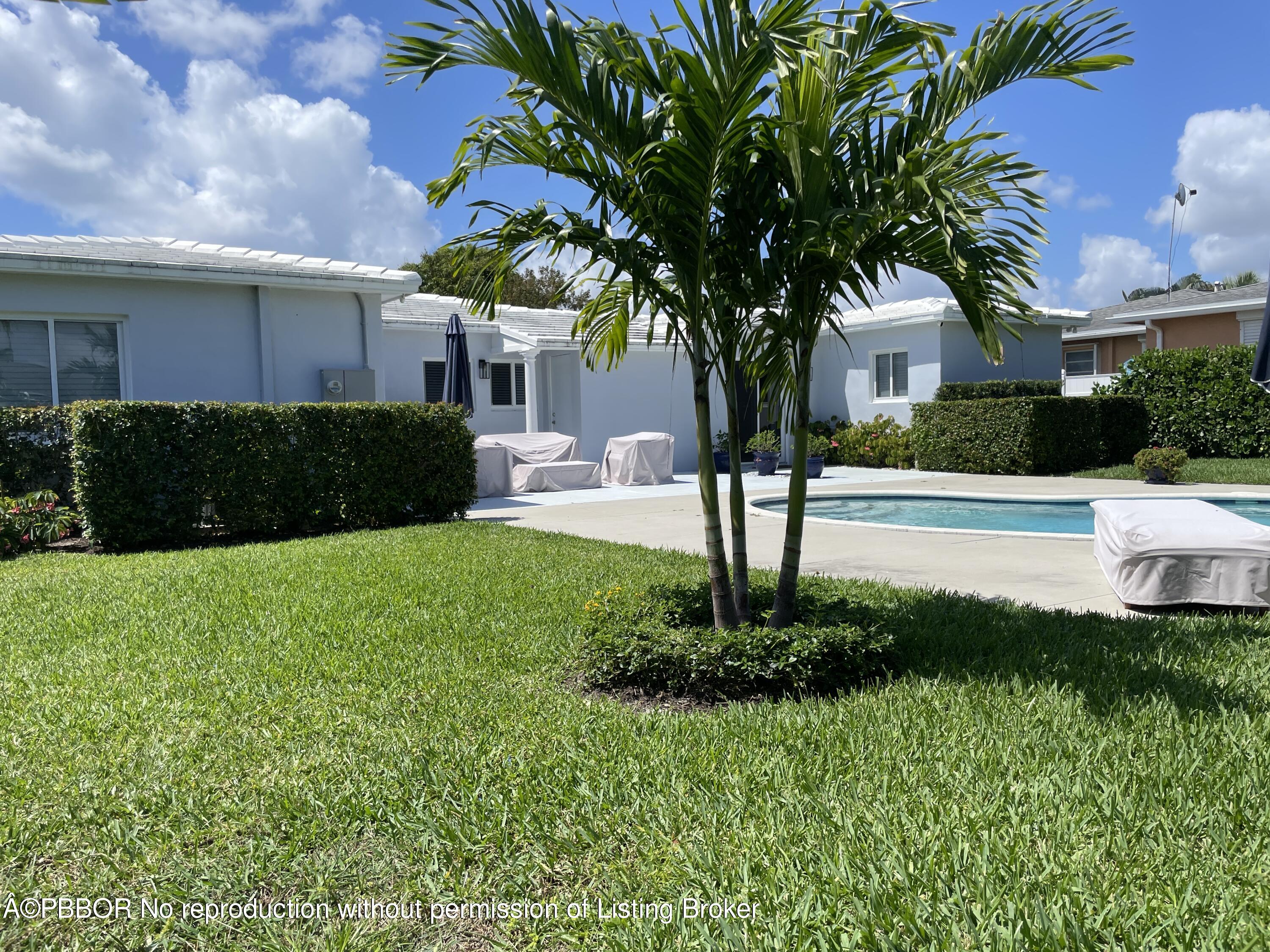 369 Valley Forge Road West Palm Beach, FL 33405 - Photo 4 of 19 a front view of a house with a yard and a tree