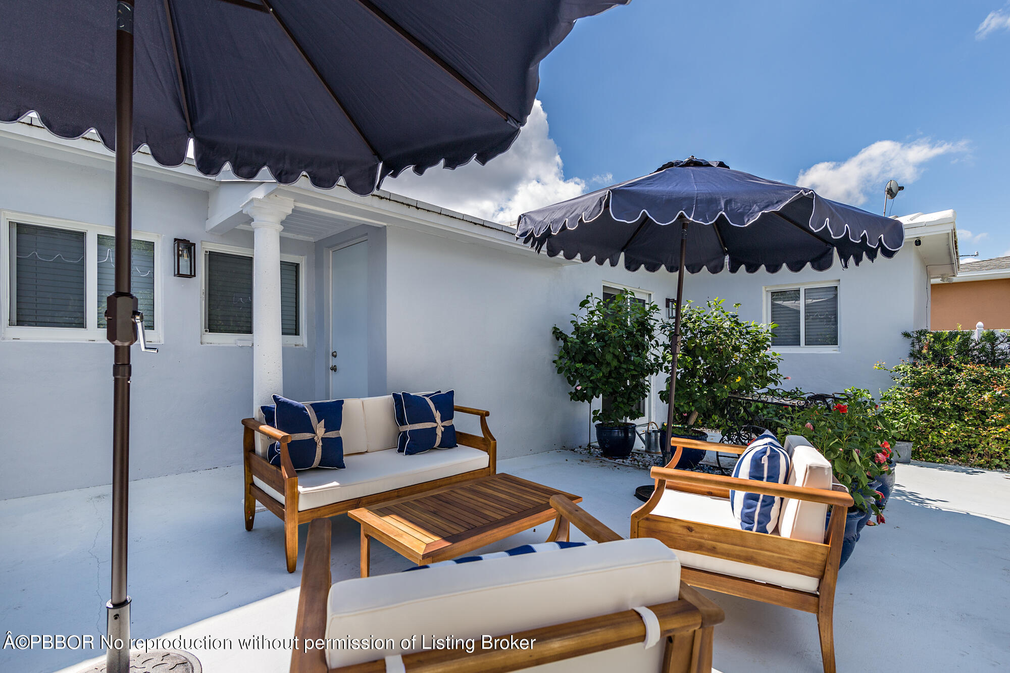 369 Valley Forge Road West Palm Beach, FL 33405 - Photo 6 of 19 a roof deck with table and chairs under an umbrella