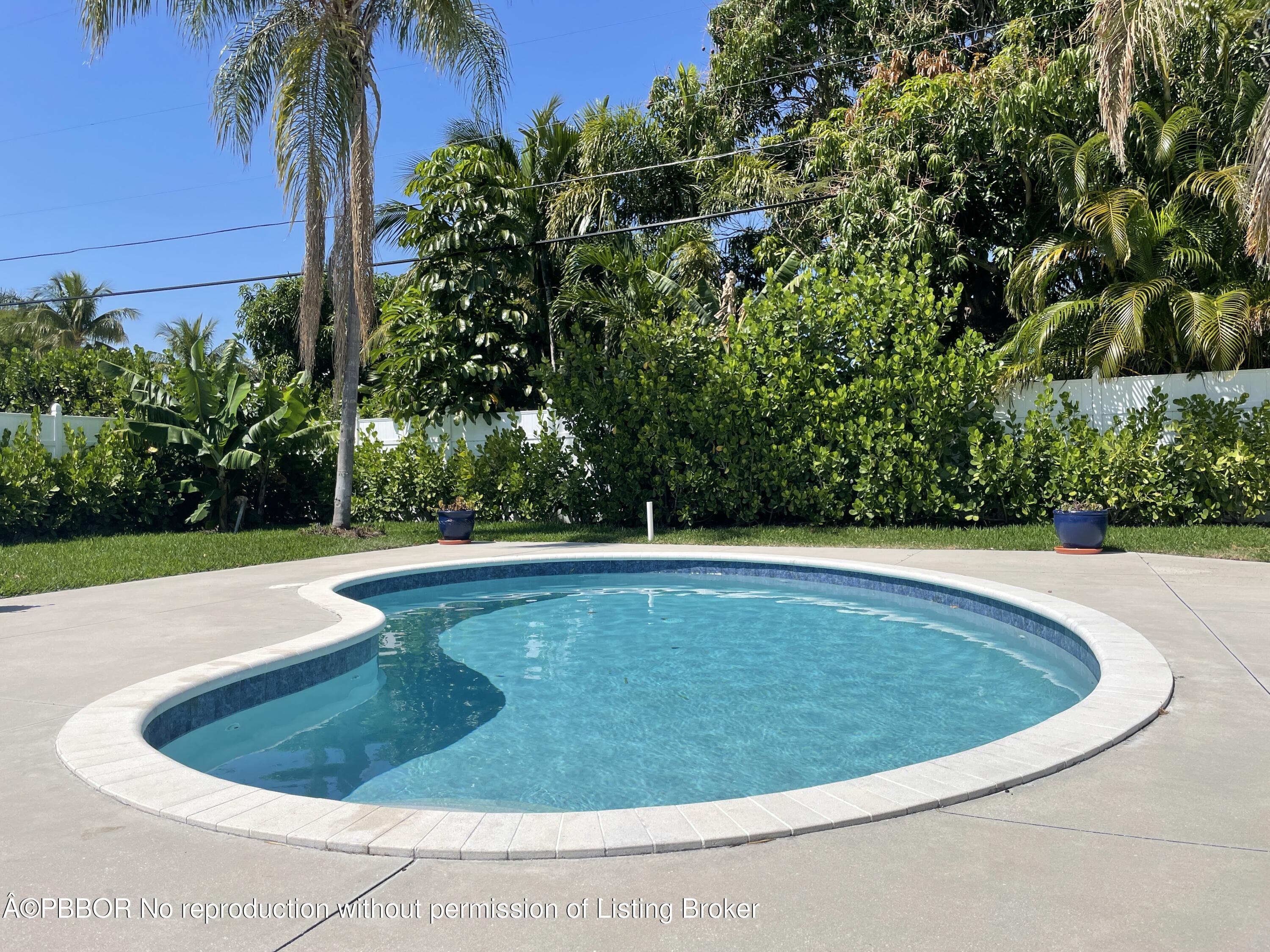 369 Valley Forge Road West Palm Beach, FL 33405 - Photo 7 of 19 a view of a swimming pool with a yard