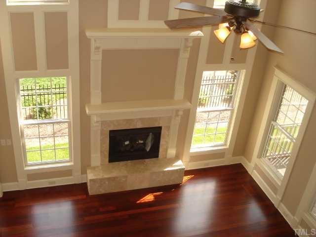 3308 Cotten Road, Unit LOT85 Raleigh, NC 27603 - Photo 9 of 12 a living room with a fireplace with wooden floor