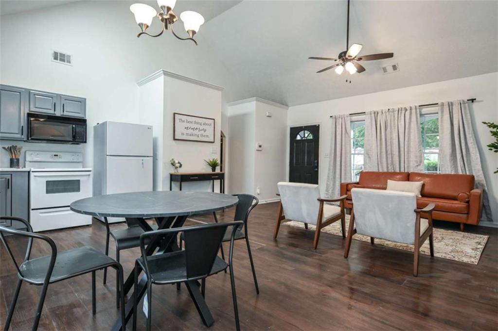 398 Arch Street Athens, GA 30601 - Photo 11 of 27 a view of a dining room with furniture a chandelier and wooden floor