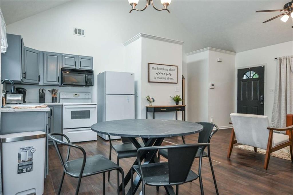 398 Arch Street Athens, GA 30601 - Photo 15 of 27 a kitchen with a table chairs refrigerator and microwave