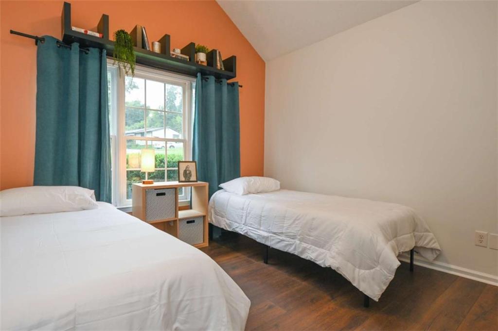 398 Arch Street Athens, GA 30601 - Photo 17 of 27 a bedroom with two beds and a window