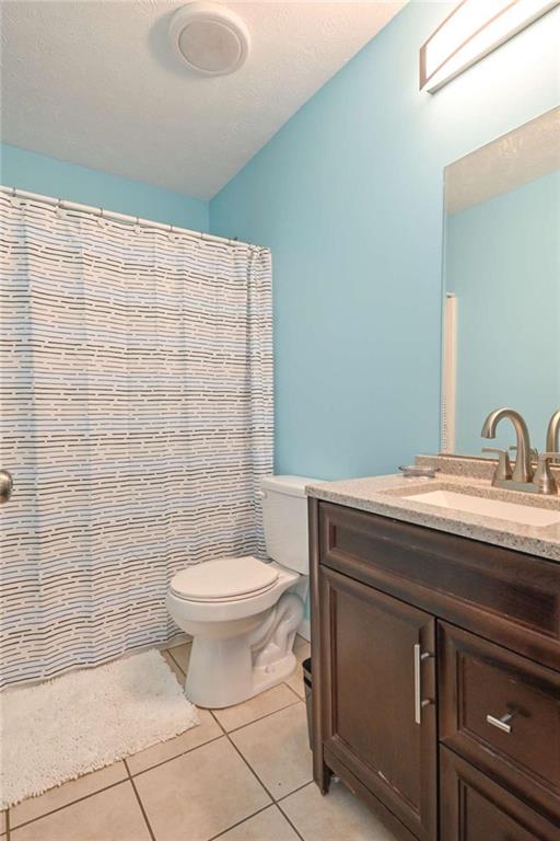 398 Arch Street Athens, GA 30601 - Photo 20 of 27 a bathroom with a granite countertop toilet and a sink