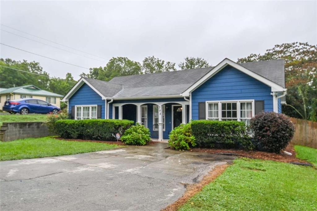 398 Arch Street Athens, GA 30601 - Photo 2 of 27 a front view of a house with a yard