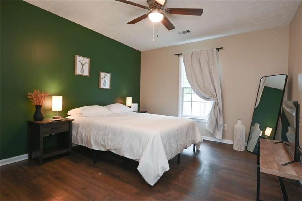 398 Arch Street Athens, GA 30601 - Photo 24 of 27 a bedroom with a bed and a chandelier