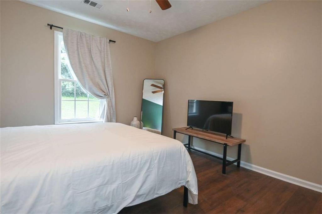398 Arch Street Athens, GA 30601 - Photo 25 of 27 a bedroom with a bed a desk and a window