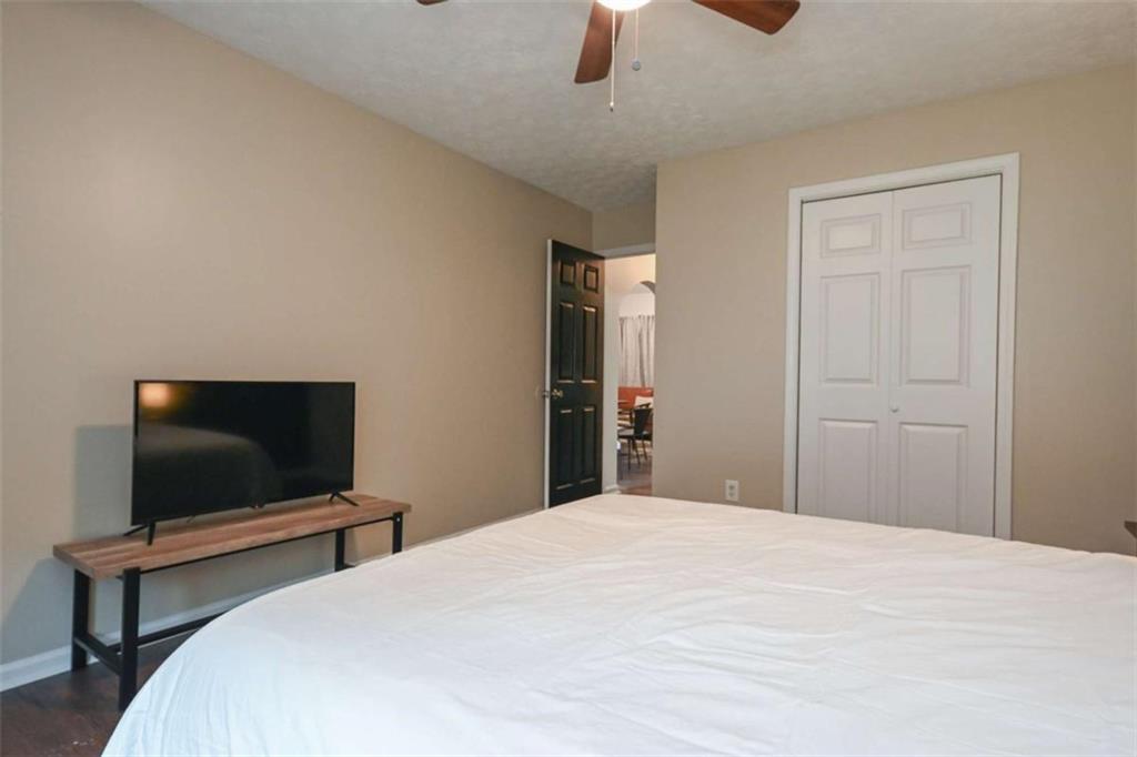 398 Arch Street Athens, GA 30601 - Photo 26 of 27 a bedroom with a bed and flat screen tv