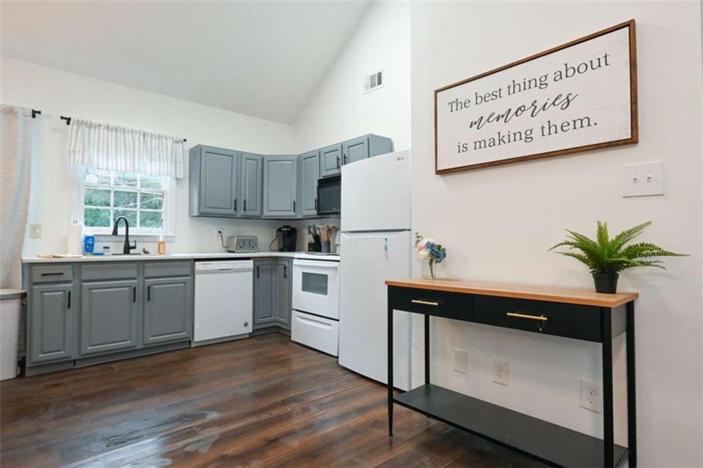 398 Arch Street Athens, GA 30601 - Photo 5 of 27 a kitchen with a refrigerator sink and cabinets