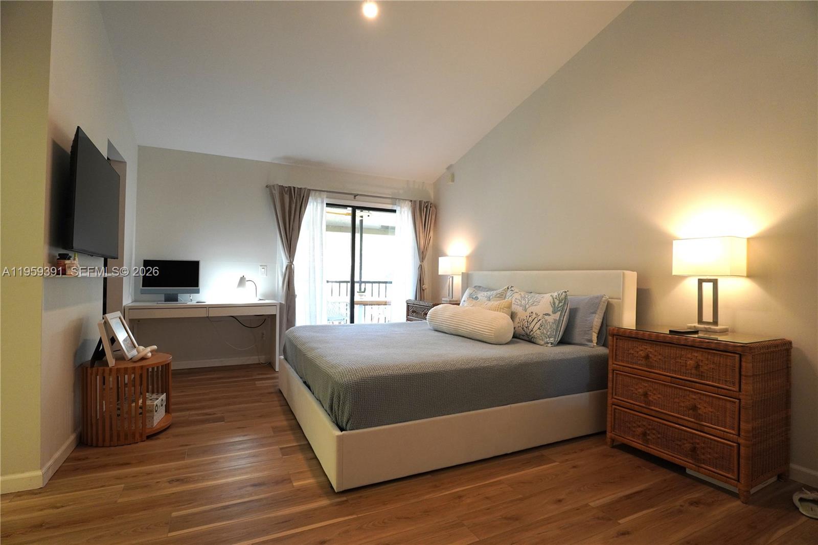 5741 Coach House Circle, Unit H Boca Raton, FL 33486 - Photo 13 of 34 a bedroom with a bed and a flat tv screen on a dresser