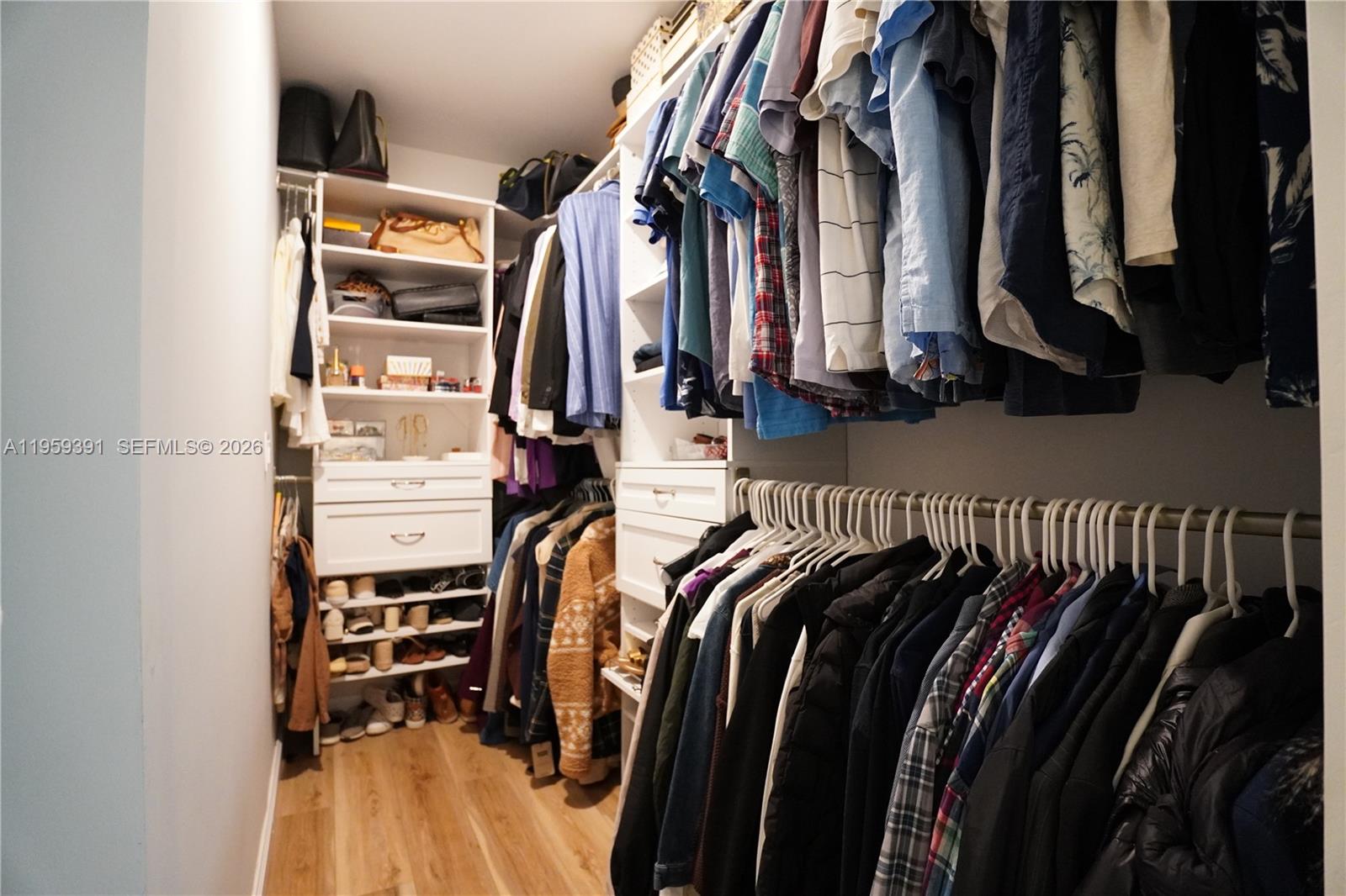 5741 Coach House Circle, Unit H Boca Raton, FL 33486 - Photo 18 of 34 a view of walk in closet with clothes and shoes