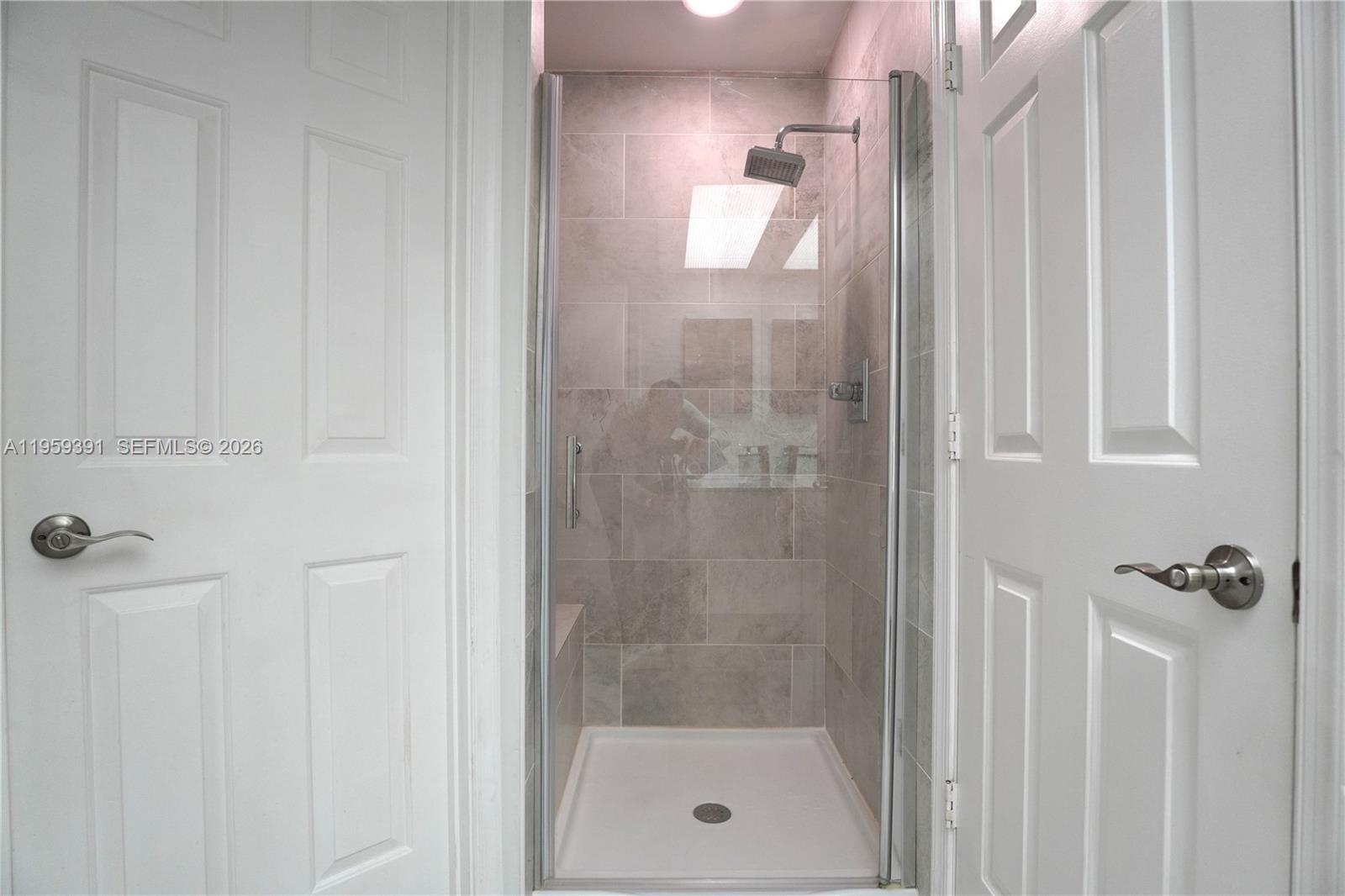 5741 Coach House Circle, Unit H Boca Raton, FL 33486 - Photo 23 of 34 a bathroom with a shower