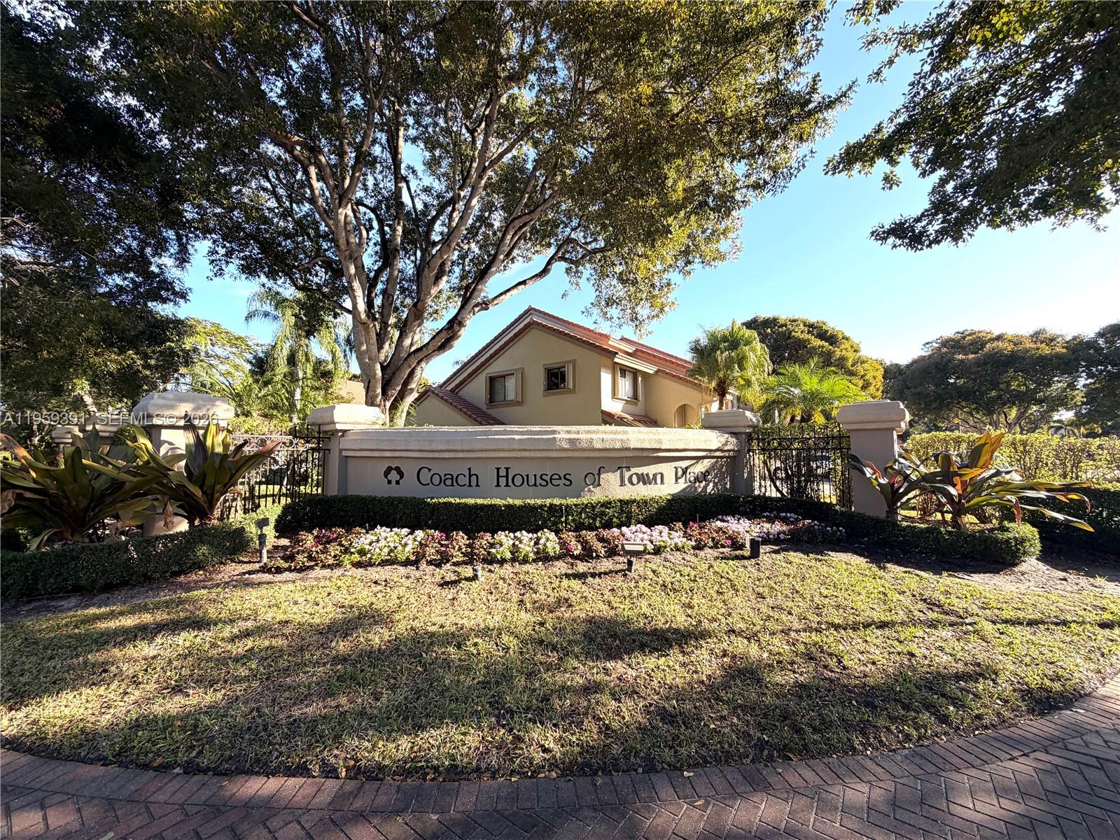 5741 Coach House Circle, Unit H Boca Raton, FL 33486 - Photo 31 of 34 a front view of a house with a yard covered with snow