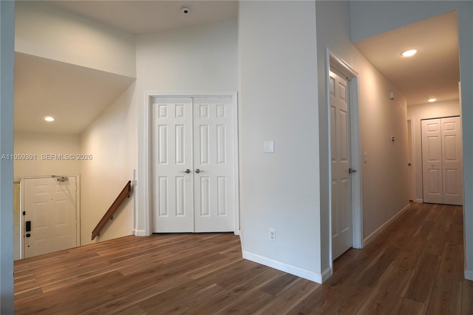 5741 Coach House Circle, Unit H Boca Raton, FL 33486 - Photo 6 of 34 a view of a hallway with wooden floor and staircase