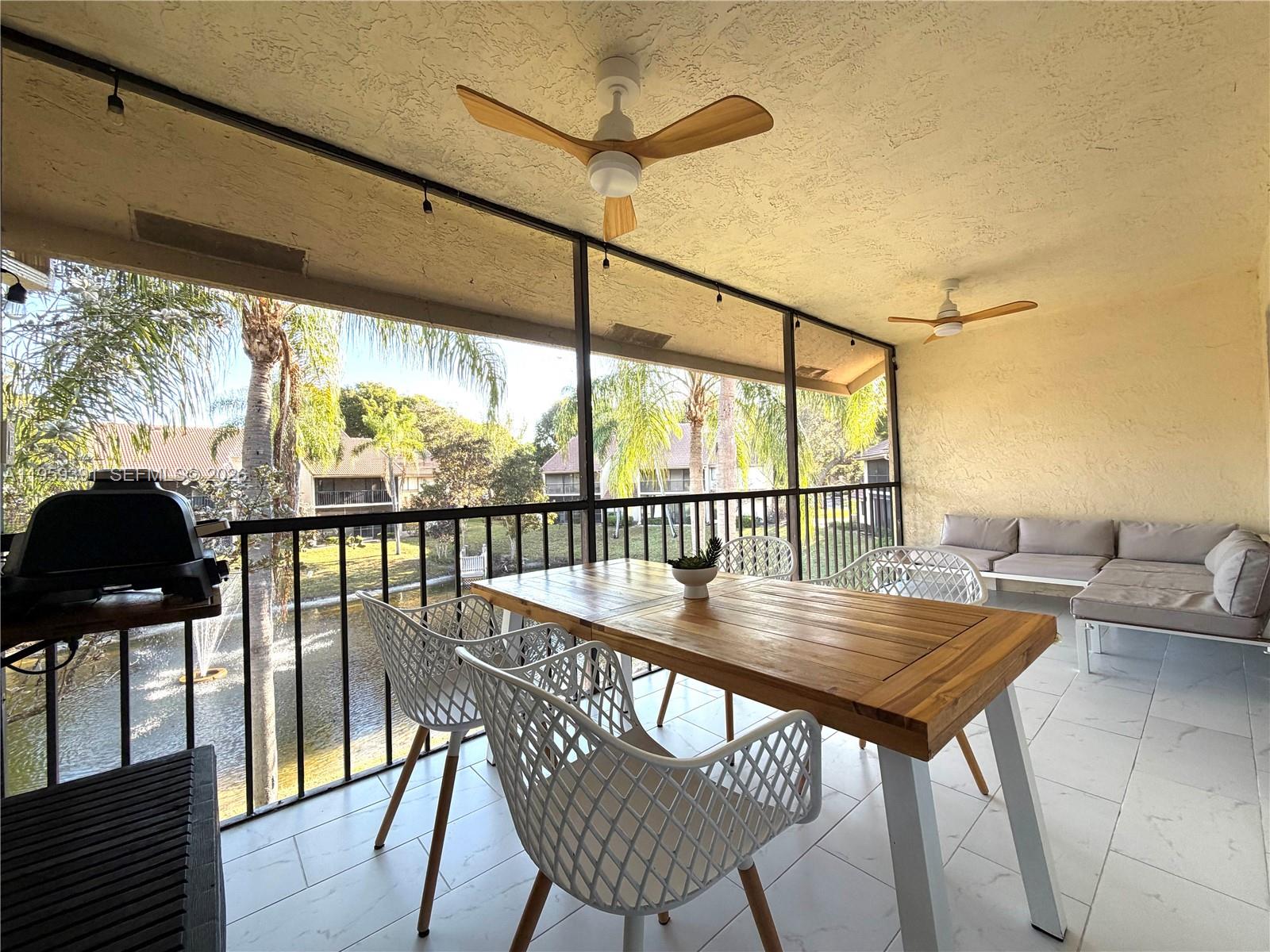 5741 Coach House Circle, Unit H Boca Raton, FL 33486 - Photo 8 of 34 a view of a city from a dining room with furniture and wooden floor