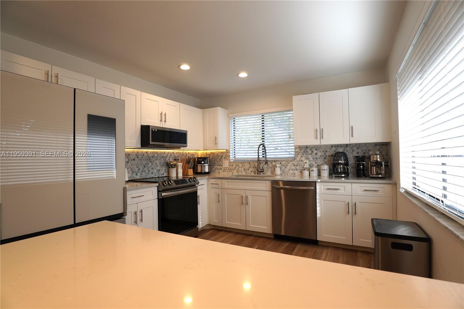 5741 Coach House Circle, Unit H Boca Raton, FL 33486 - Photo 9 of 34 a kitchen with a sink stainless steel appliances and window