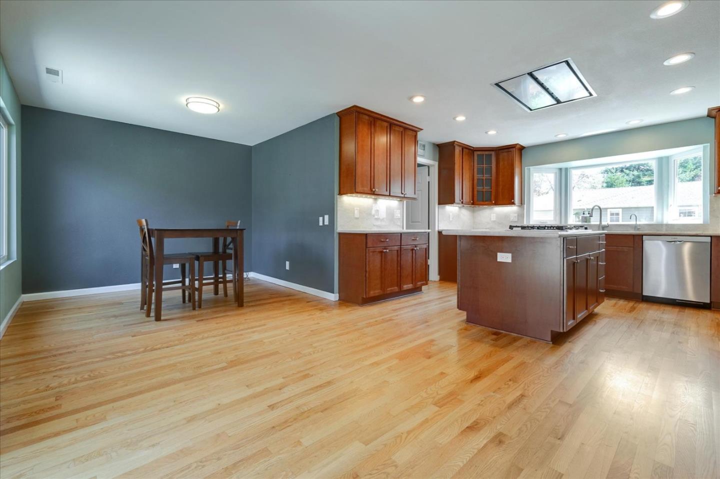 7128 Danko Drive Aptos, CA 95003 - Photo 15 of 47 a kitchen with stainless steel appliances granite countertop a stove and a wooden floors
