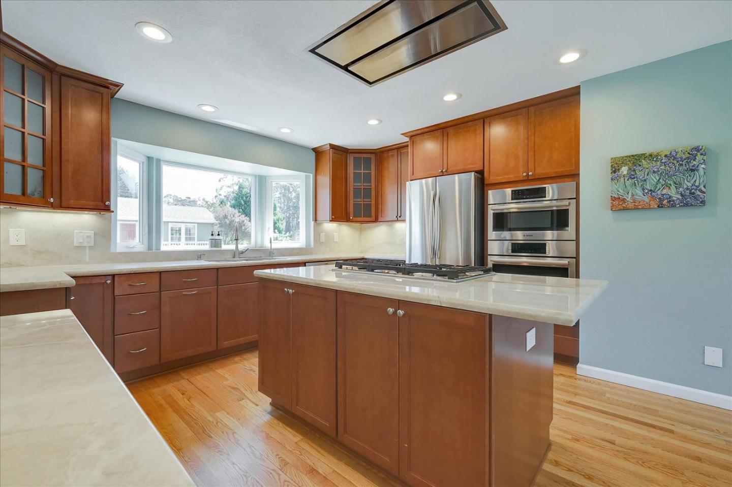 7128 Danko Drive Aptos, CA 95003 - Photo 16 of 47 a kitchen with stainless steel appliances granite countertop refrigerator sink and microwave