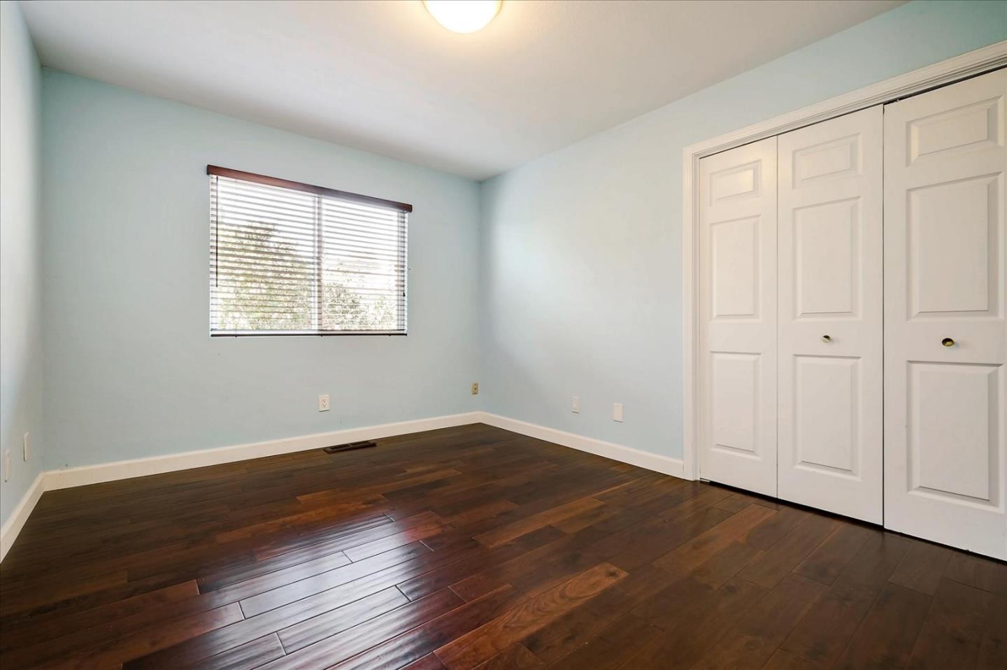 7128 Danko Drive Aptos, CA 95003 - Photo 31 of 47 an empty room with wooden floor and windows