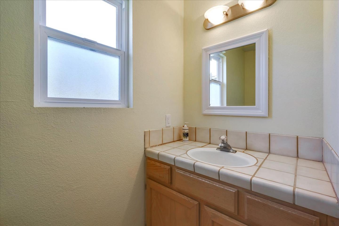 7128 Danko Drive Aptos, CA 95003 - Photo 33 of 47 a bathroom with a sink and a mirror