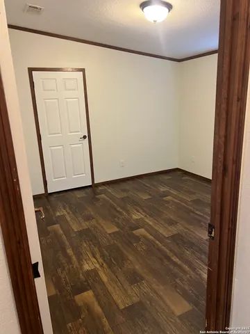 an empty room with wooden floor