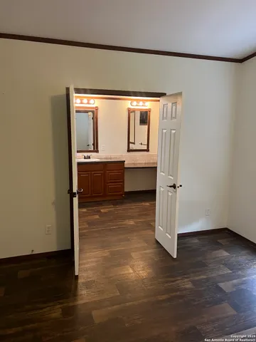 a room with wooden floor and a window