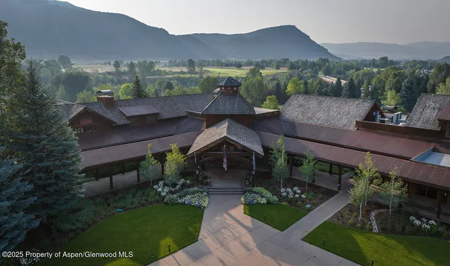 a view of a house with pool and chairs