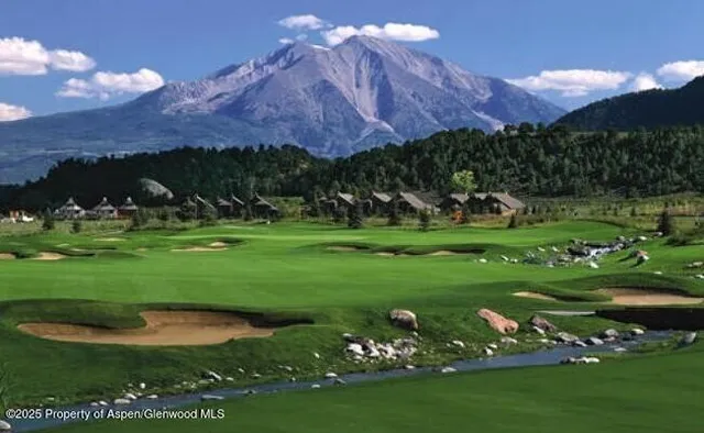 a view of a golf course with a lake