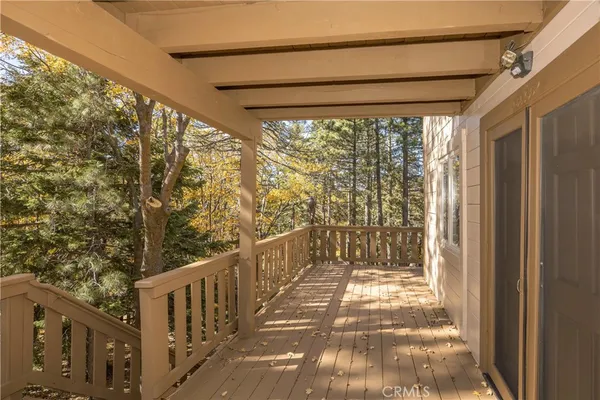 a view of a balcony with wooden fence and floor