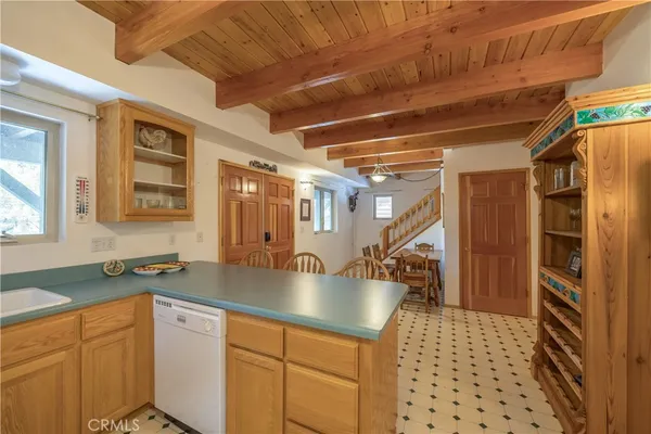 a kitchen with granite countertop a sink a stove and cabinets
