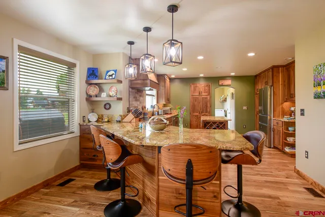 a living room with furniture a floor to ceiling window and a flat screen tv