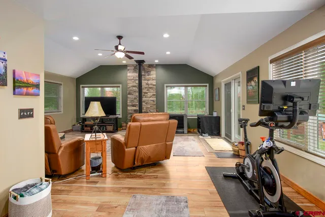 a living room with furniture a ceiling fan and a rug