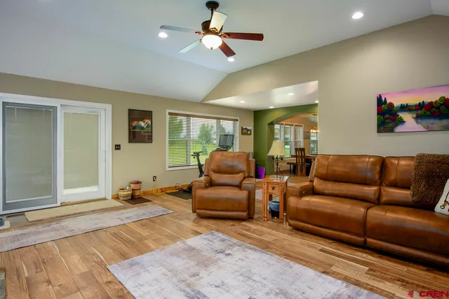 a bedroom with a bed a chandelier and a dresser