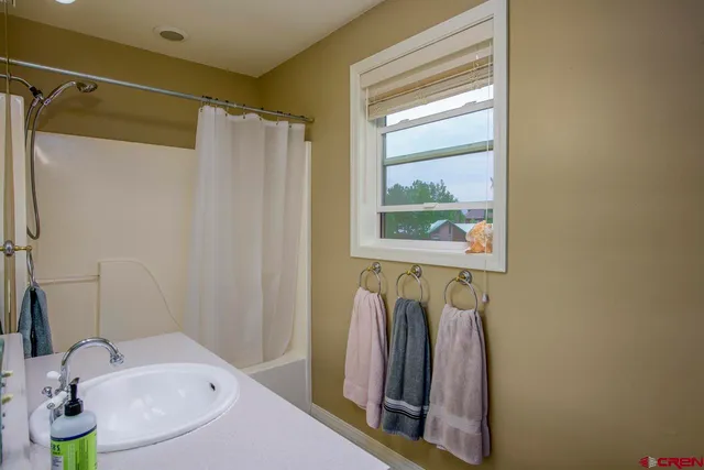 a bedroom that has a bed and a chair in it