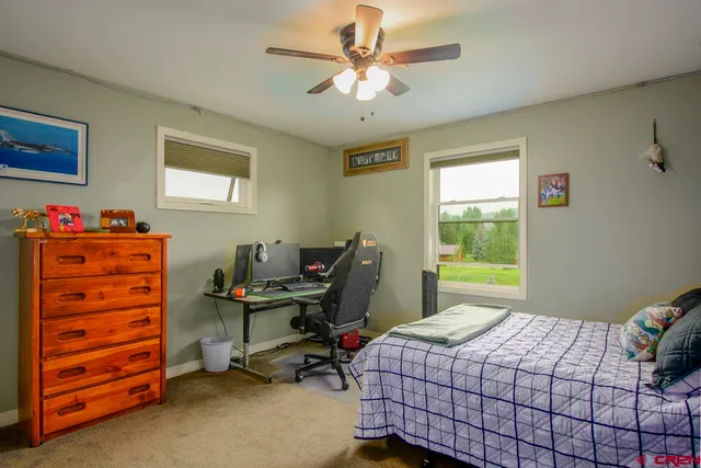 a bedroom with a bed and a lamp