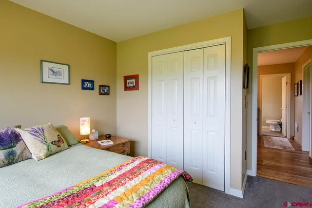 a bedroom with a bed and a table chair